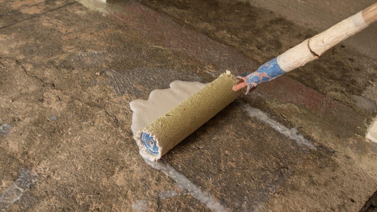 Preparing concrete with a concrete primer using a long paint roller