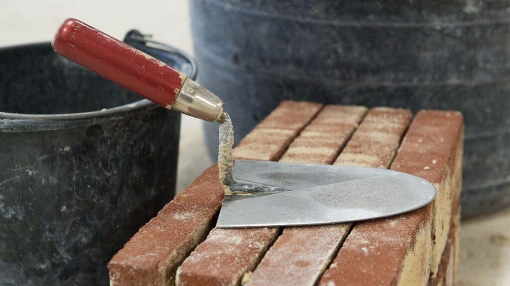 A trowel and brick for cutting slate