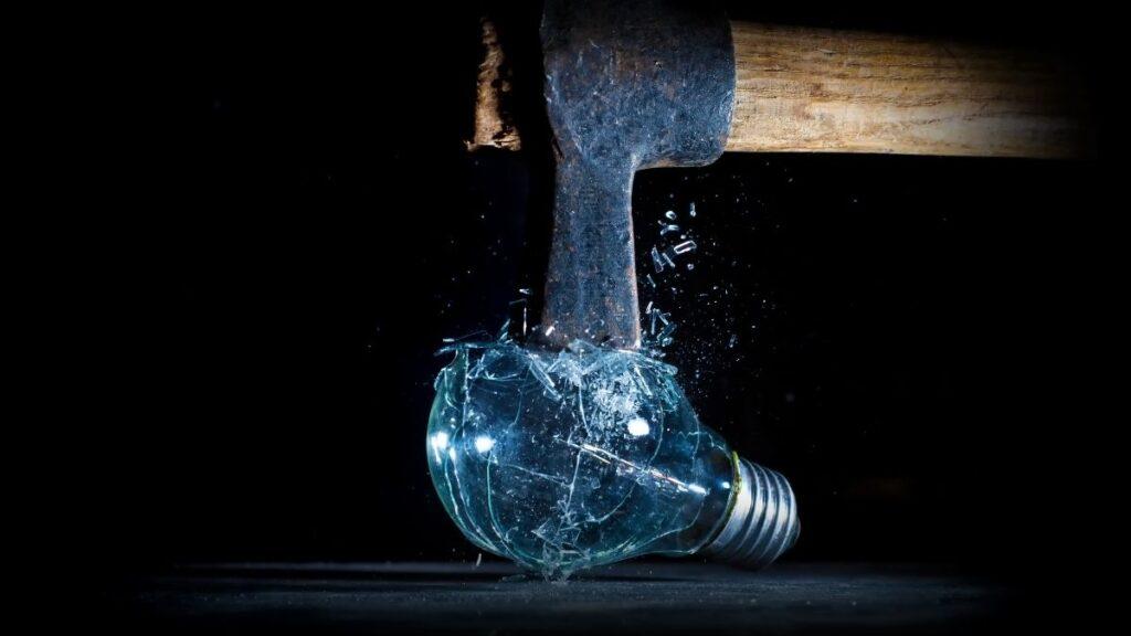 Crushing a glass bulb with a hammer