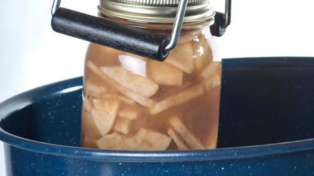 Putting a canning jar into a water bath
