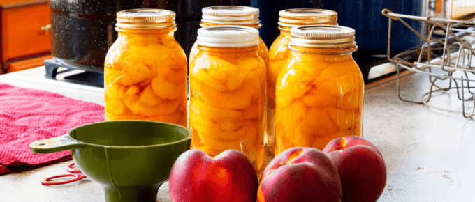 whole peaches sitting in front of canned peaches