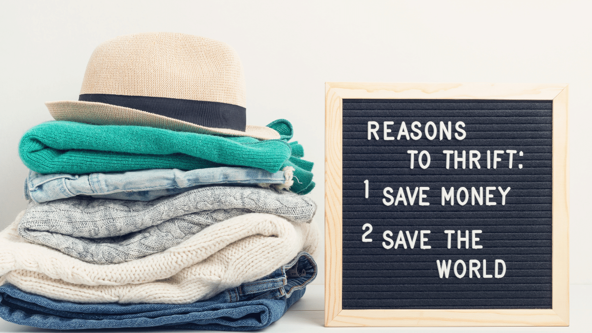 pile of clothes beside a board that lists reasons to thrift