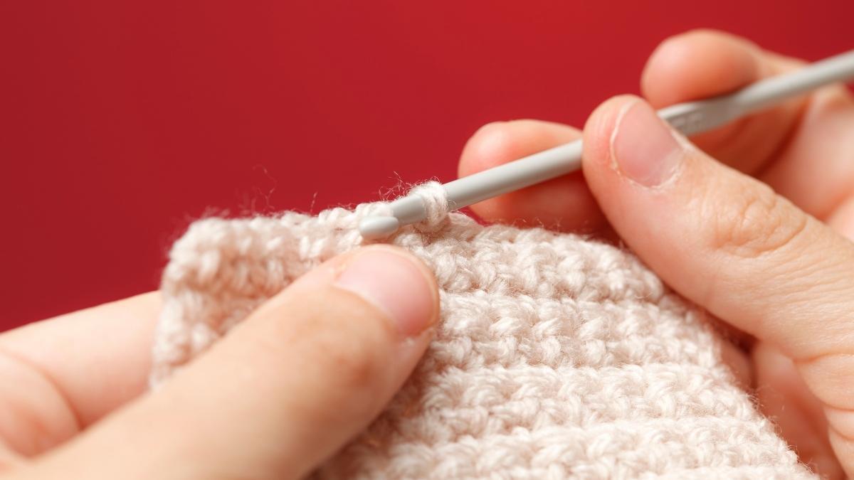 Hands crocheting in a straight line
